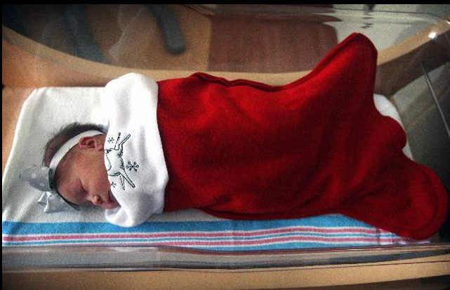 New born baby bundled in Christmas stocking